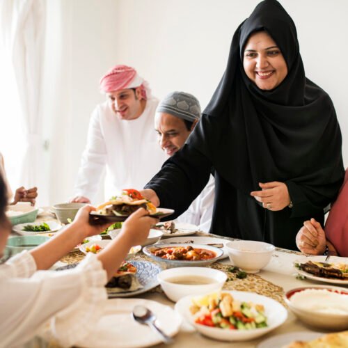 Muslim woman sharing food at Ramadan feast Muslim woman sharing food at Ramadan feast